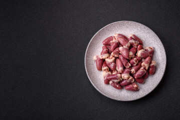Raw chicken hearts with salt, spices and herbs