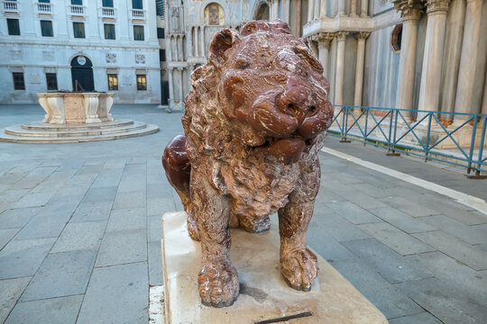 Close up view of red marble lions in the Piazzetta dei Leoncini at St Mark's Square, Venice, Veneto, Italy, Europe. Tourist landmark in the old town center. Urban summer tourism