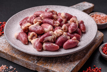 Raw chicken hearts with salt, spices and herbs