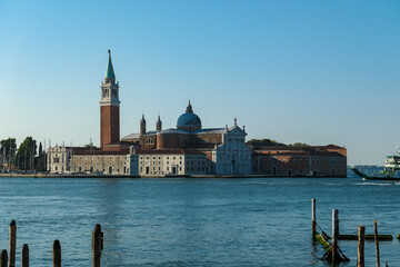 Fototapeta premium Scenic view of church on the Island of San Giorgio Maggiore, Venice, Veneto, Northern Italy, Europe. Perspective from San Mark Square. Soft light in tranquil atmosphere. Boat trip in Venetian lagoon