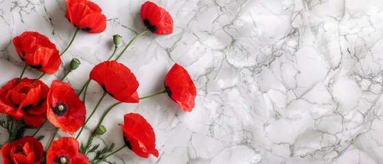   A red flower arrangement sits atop a white marble countertop, accompanied by an additional bunch of red flowers nearby