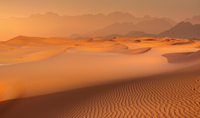 Fototapeta na wymiar Panoramic view of orange sand dune desert with orange mountains and hill - Namib desert, Namibia