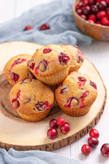 dried cranberry muffins on a wooden table