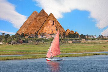Beautiful Nile scenery with traditional Felluca sailing boat in the Nile on the way to Giza pyramids and The great Sphinx  - Cairo, Egypt  