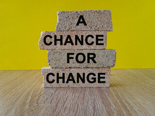 Concept words A chance for change on beautiful brick blocks. Beautiful yellow background, wooden...