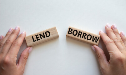 Lend or Borrow symbol. Concept word Lend or Borrow on wooden blocks. Businessman hand. Beautiful white background. Business and Lend or Borrow concept. Copy space