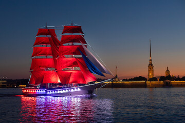 Saint-Petersburg. Holiday of Scarlet Sails. Russia. A sailboat sails on the river. White night show on the Neva River in St. Petersburg, romantic ship with scarlet sails