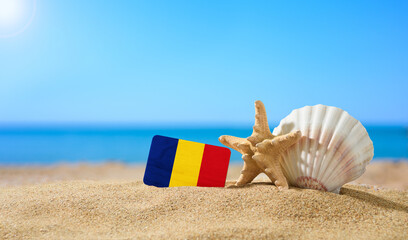 Beautiful beach in Romania. Flag of Romania in the shape of a heart and shells on a sandy beach.