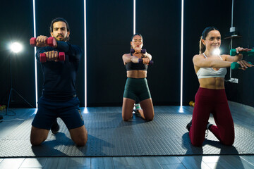 Group of fitness coaches performing during a fitness class recording
