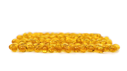 A group of yellow capsules isolated on a white background.