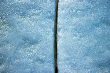 Ice and crack, crevice. Ice and snow texture.