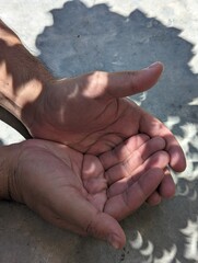 Eclipse in hands on cement background