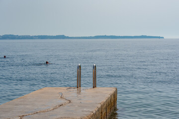 Metal steps leading to the Adriatic sea at the port of Piran, Slovenia
