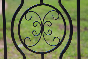A steel ornament in a decorative fence
