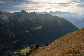 View of Swiss Alps near Fronalpstock in Stoos, Switzerland. Walking trails and mountain valley. Bright, sunny day.