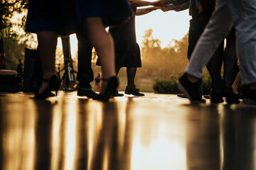 people dancing after rain in sunset golden hour on wet ground
