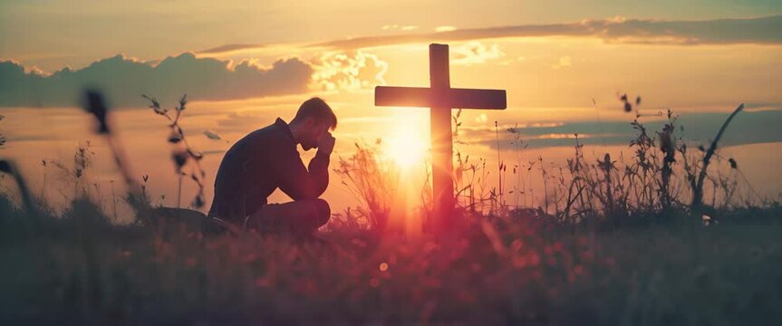 Christian man praying in front of the cross