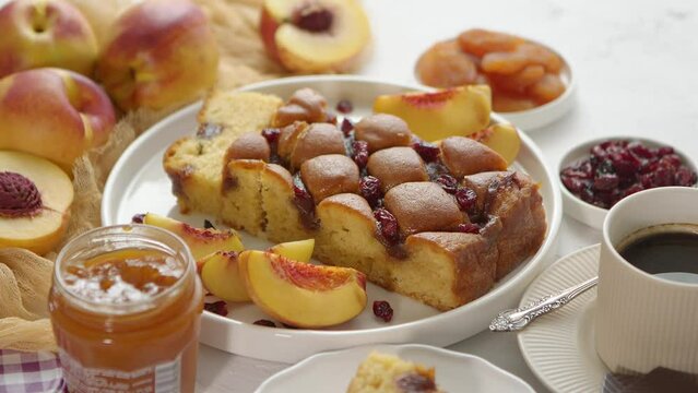 Homemade Peach Cake on Table With Fresh Fruit and Coffee