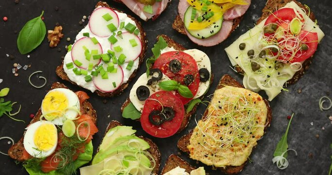 Assorted Open Sandwiches on a Dark Slate Background