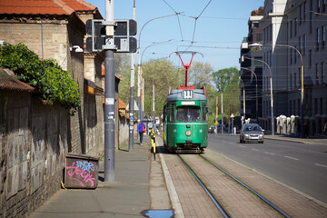 old green tram in the center of Belgrade. Retro tram on the street of the historical city center