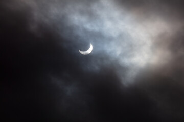 Obraz na płótnie Canvas Solar eclipse 2024 seen through a cloudy sky near Toronto. Photo taken moment after the total eclipse.