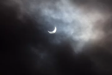Tuinposter Solar eclipse 2024 seen from a cloudy sky near Toronto. Photo taken after the total eclipse. © hpsens