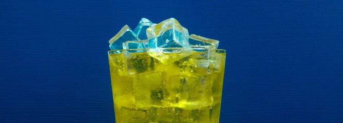 Golden Inca Kola Soda Glass with Ice on Blue Background in 4K Image