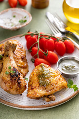 Roasted chicken drumsticks and thighs with pesto and tomatoes