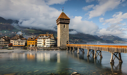 Kapellbrücke over water with a tower and buildings in the background - obrazy, fototapety, plakaty