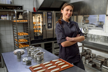 Woman baker producing classic croissants at bakery