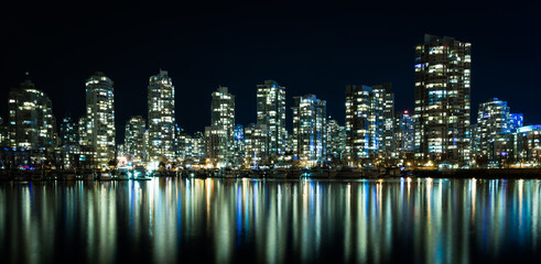 Vancouver city skyline at night, Brithish Columbia, Canada. Colorful reflections of city buildings in False Creek.