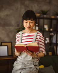 one female mature japanese woman read book at home
