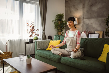 Mature japanese woman practice guided meditation manifestation at home