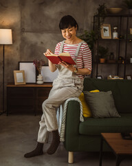 Naklejka premium one female mature japanese woman read book at home