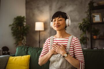 Mature japanese woman practice guided meditation manifestation at home