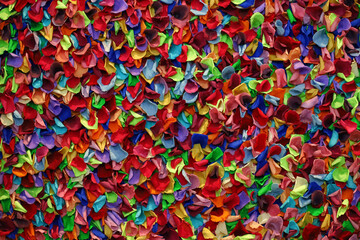Background material close-up on a wall decorated with colorful flower petals