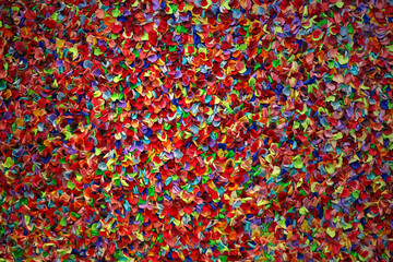 Fototapeta na wymiar Background material close-up on a wall decorated with colorful flower petals