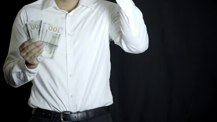 man showing happiness for receiving 100 dollar bills, commemorating salary, investments, financial gains