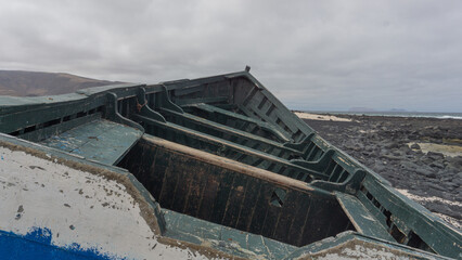 Abandoned Rowboat on Rocky Shoreline