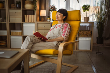 one female mature japanese woman read book at home