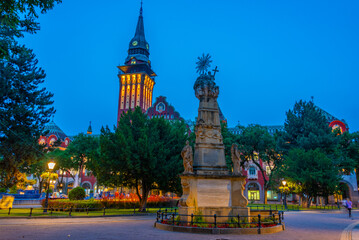 Sunset view of the holy trinity monument and Art nouveau town ha