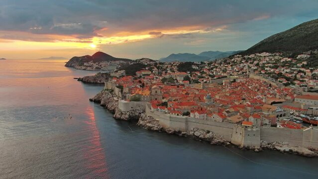 Aerial around view of Dubrovnik at sunset, city in southern Croatia coast of Adriatic Sea, Europe, 4k