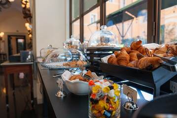 Breakfast buffet in a luxury hotel in Rome elegant setup with pastries, bread rolls, croissants,...