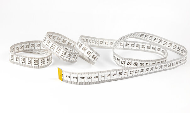 A measuring tape used by tailors for sewing clothes. Sewing concept.