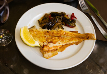 Lenguado fish (sea tongue or European salt) baked served with stewed vegetables