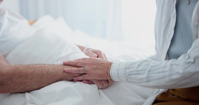 Hospital, bed and holding hands for couple, support and empathy in healthcare. Love, care and trust for married people for sickness diagnose, senior and comfort for medical help with compassion