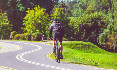 Fototapeta premium Cyclist ride on the bike path in the city Park 