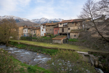 Architecture of the Jewish Quarter of Hervas Extremadura in Hervas with snow capped mountains and the Ambroz river