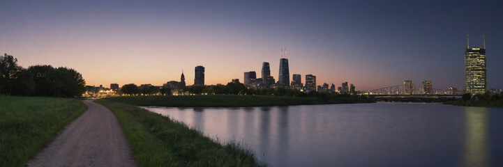 Fototapeta na wymiar Sunset and Greater City in the background of a beautiful river lake