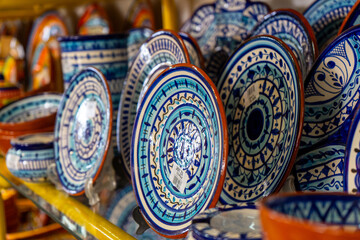 Variety of traditional earthenware cups, bowls and others handmade from varnished baked clay in...